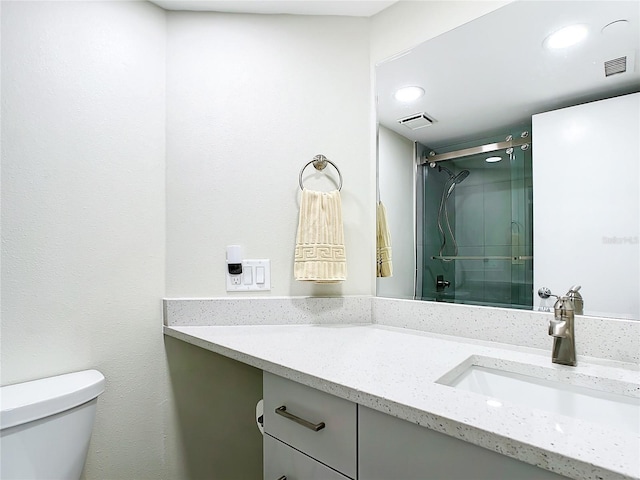 bathroom with vanity, toilet, and walk in shower