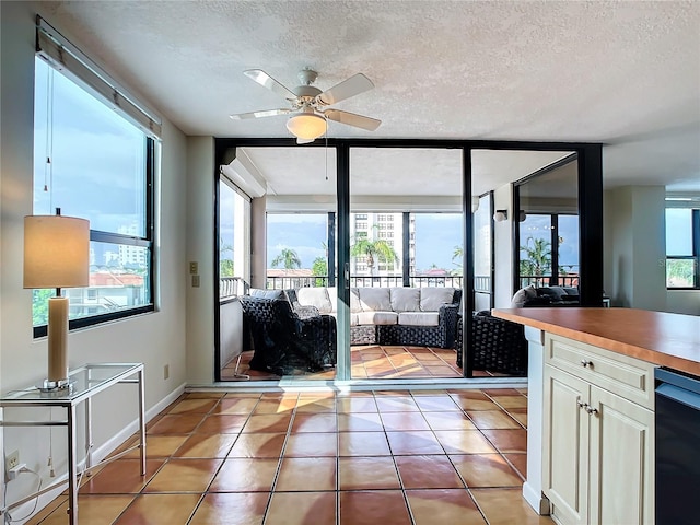 doorway to outside with light tile patterned flooring and a textured ceiling