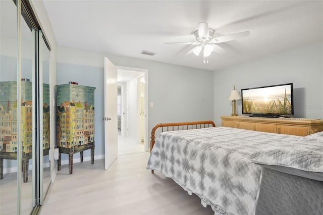 bedroom with a closet, ceiling fan, and light hardwood / wood-style flooring