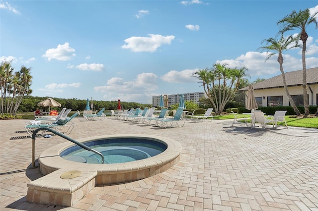 view of pool featuring a community hot tub and a patio area