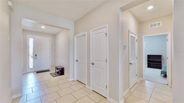 foyer entrance with light tile floors