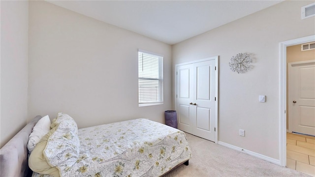 carpeted bedroom with a closet