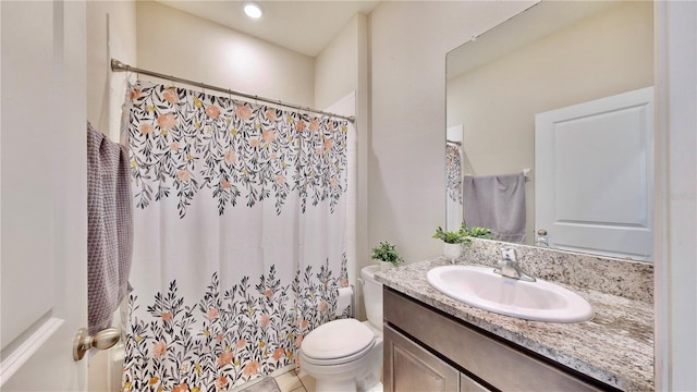 bathroom with vanity, toilet, and tile floors