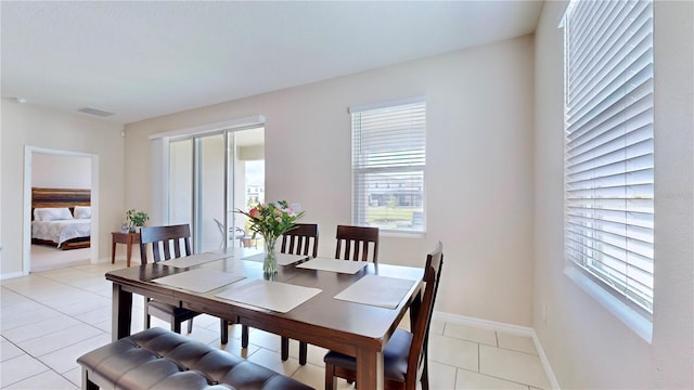 dining space with light tile floors