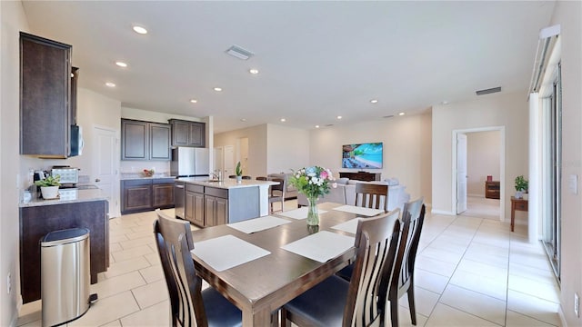 dining area featuring light tile floors