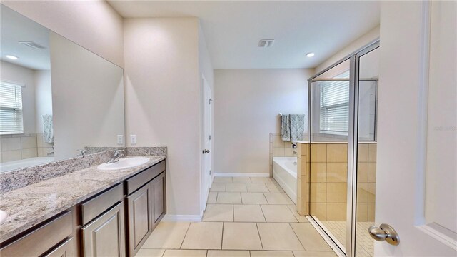 bathroom with tile floors, plus walk in shower, and vanity