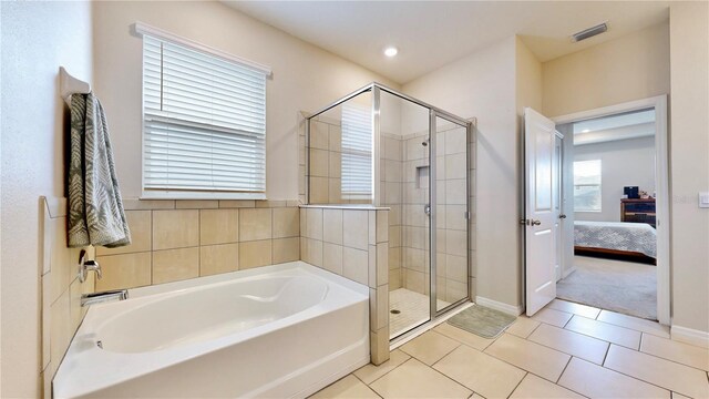 bathroom featuring tile floors and shower with separate bathtub