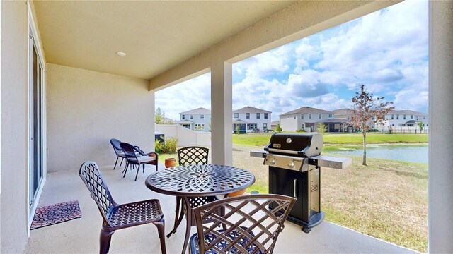 view of patio / terrace featuring a grill and a water view