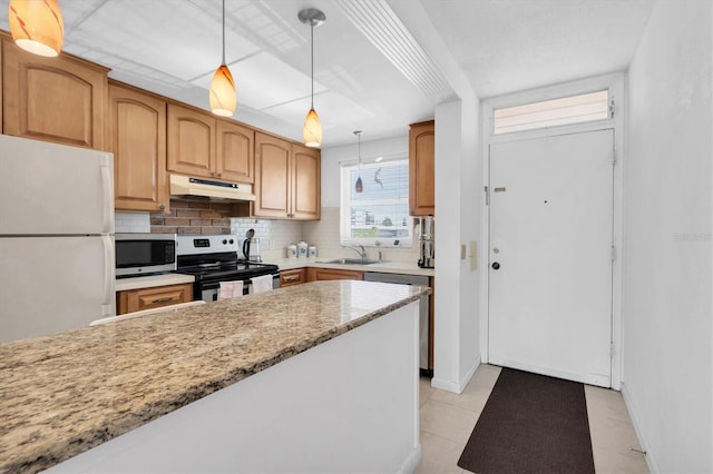 kitchen featuring decorative light fixtures, stainless steel appliances, tasteful backsplash, sink, and light tile floors