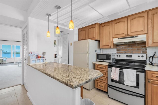 kitchen with hanging light fixtures, light tile floors, tasteful backsplash, and appliances with stainless steel finishes