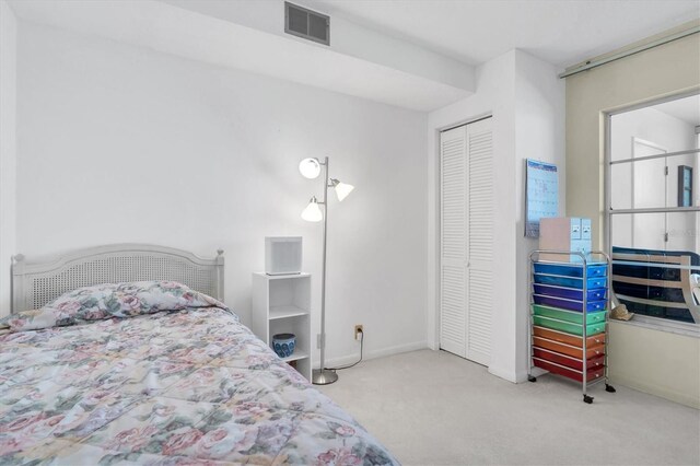 carpeted bedroom featuring a closet