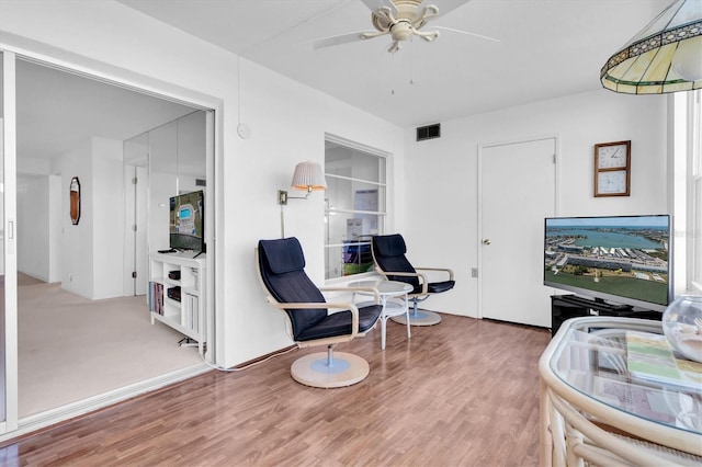 living area featuring ceiling fan and wood-type flooring