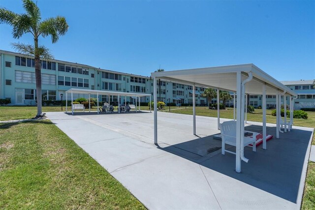 view of property's community with a carport and a yard