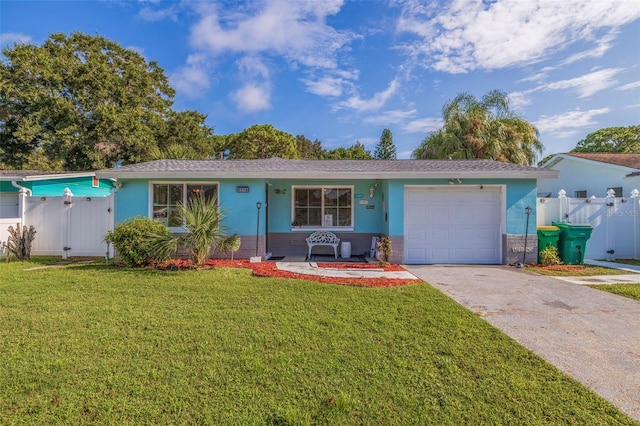 ranch-style home featuring concrete driveway, an attached garage, a front lawn, and stucco siding