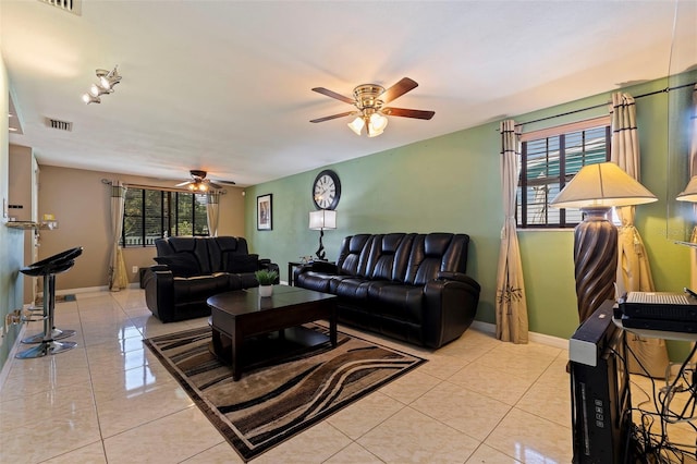 living room with visible vents, ceiling fan, baseboards, and light tile patterned floors