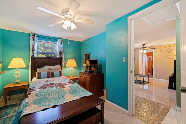 bedroom featuring a ceiling fan, baseboards, and light tile patterned floors