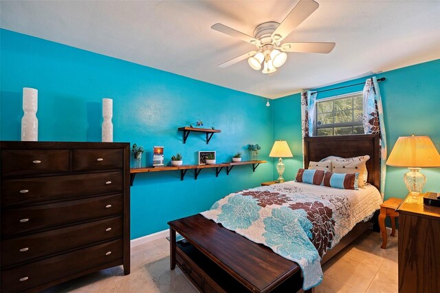 bedroom featuring ceiling fan and light tile patterned flooring