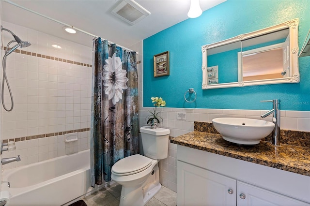 full bath featuring tile walls, visible vents, toilet, shower / bath combo with shower curtain, and tile patterned floors