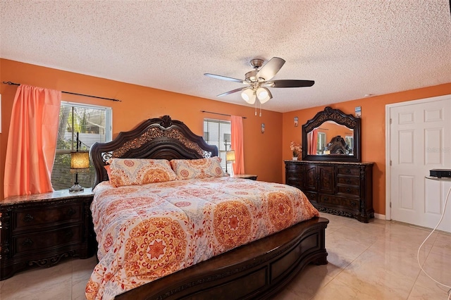 bedroom featuring ceiling fan and a textured ceiling