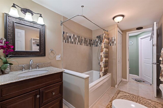 full bathroom featuring tile patterned flooring, vanity, shower / tub combo with curtain, and toilet