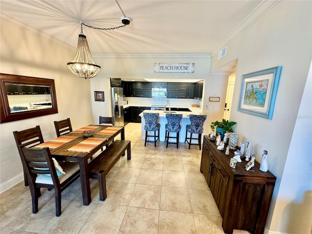 dining room with light tile patterned floors, crown molding, and an inviting chandelier