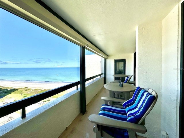 balcony with a view of the beach and a water view