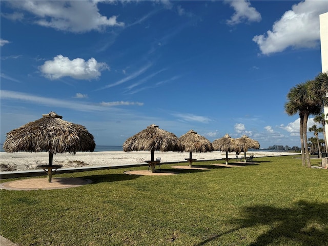 surrounding community featuring a water view and a lawn