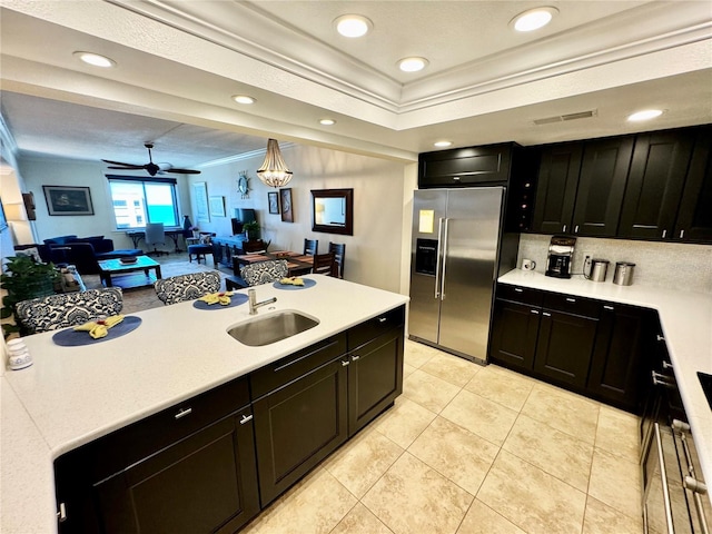 kitchen featuring stainless steel refrigerator with ice dispenser, sink, ornamental molding, light tile patterned flooring, and ceiling fan