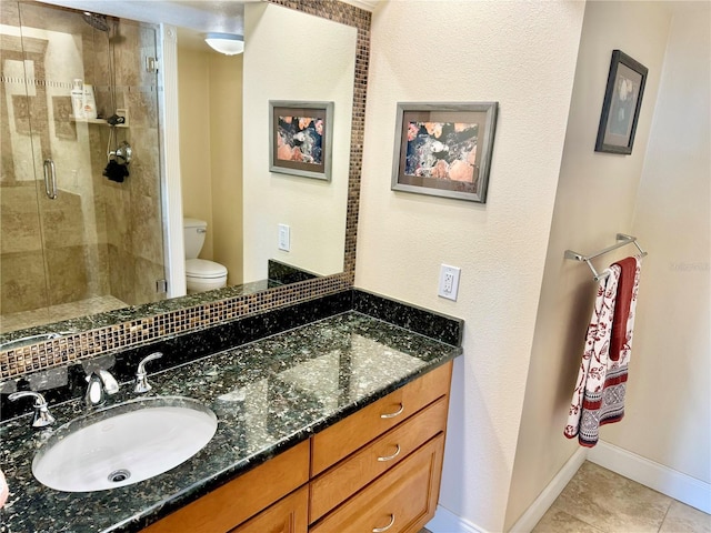 bathroom with toilet, vanity, tile patterned flooring, and a shower with door