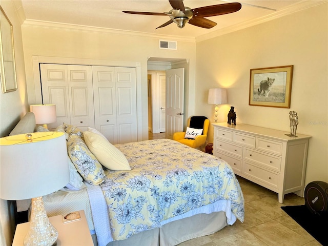 tiled bedroom with ceiling fan, a closet, and ornamental molding