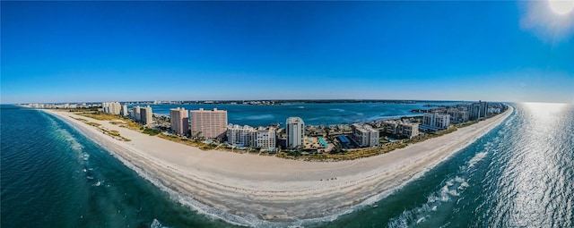 birds eye view of property featuring a water view and a beach view