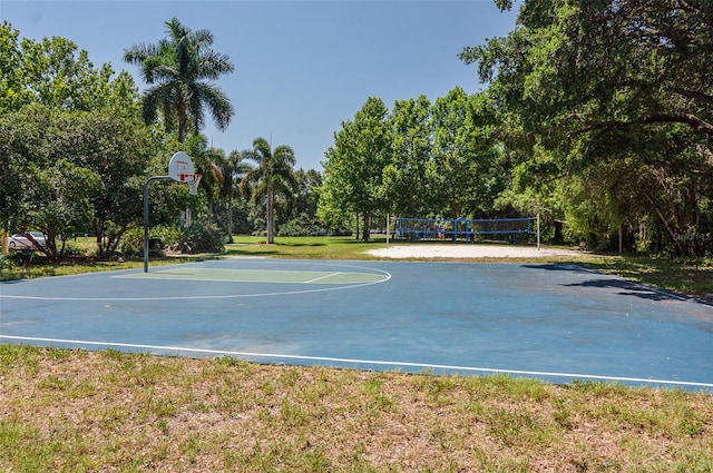 view of sport court with volleyball court and a yard