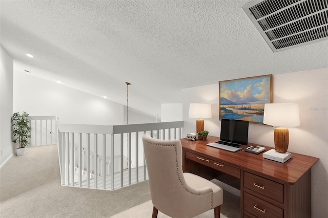 home office featuring light carpet, visible vents, a textured ceiling, and lofted ceiling