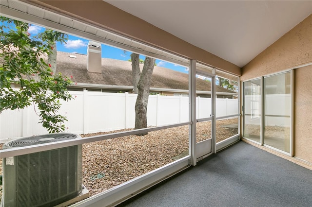 unfurnished sunroom featuring vaulted ceiling