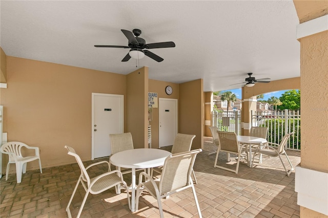 view of patio / terrace featuring ceiling fan, outdoor dining space, and fence