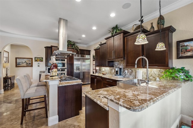 kitchen featuring backsplash, a sink, crown molding, dark brown cabinetry, and appliances with stainless steel finishes