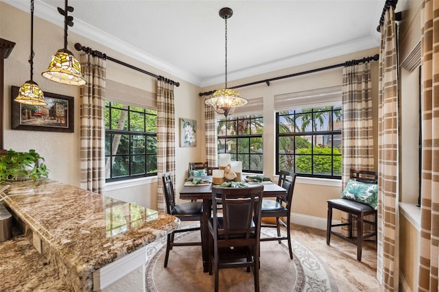 dining area with baseboards, a chandelier, and crown molding