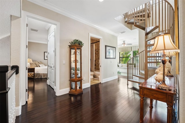 corridor with stairway, crown molding, and wood finished floors