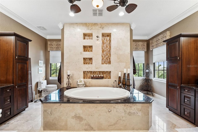 bathroom featuring toilet, plenty of natural light, visible vents, ceiling fan, and ornamental molding