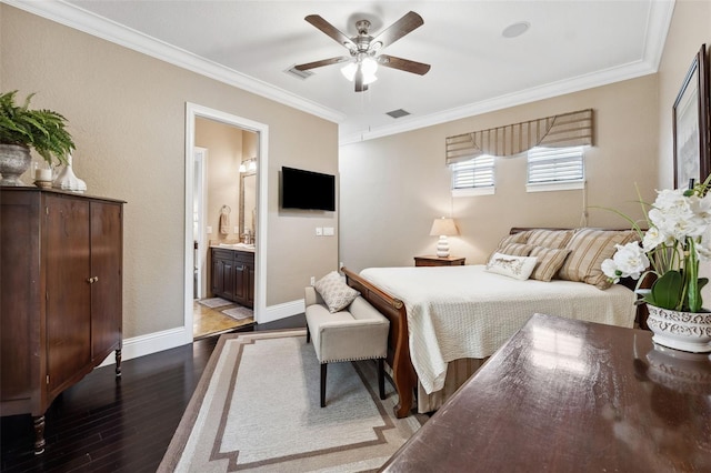 bedroom with dark wood-style floors, crown molding, connected bathroom, baseboards, and visible vents