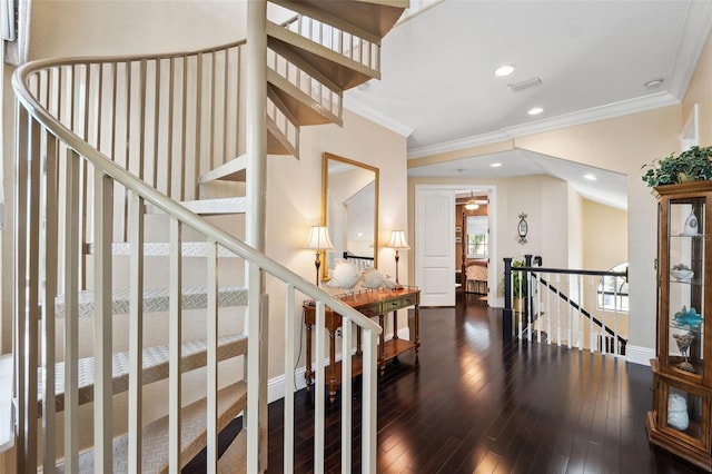interior space with hardwood / wood-style flooring, baseboards, ornamental molding, visible vents, and recessed lighting
