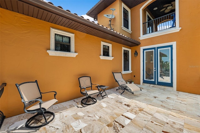 view of patio with a balcony and french doors