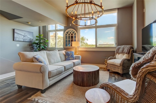 living room with dark hardwood / wood-style flooring and a chandelier