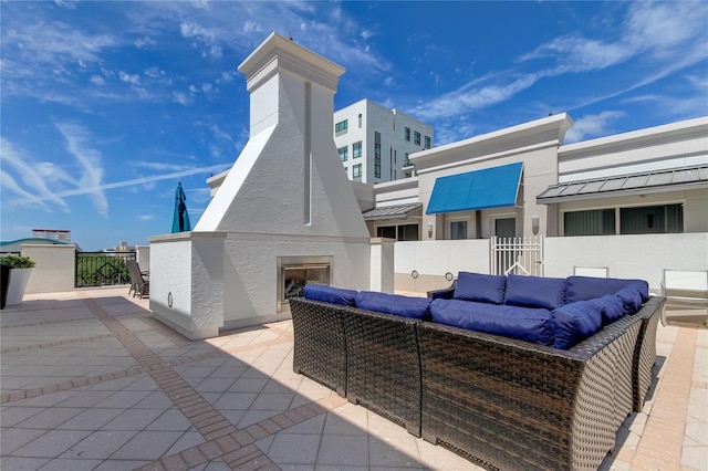 view of patio with an outdoor living space with a fireplace