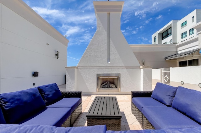 view of patio / terrace with an outdoor living space with a fireplace