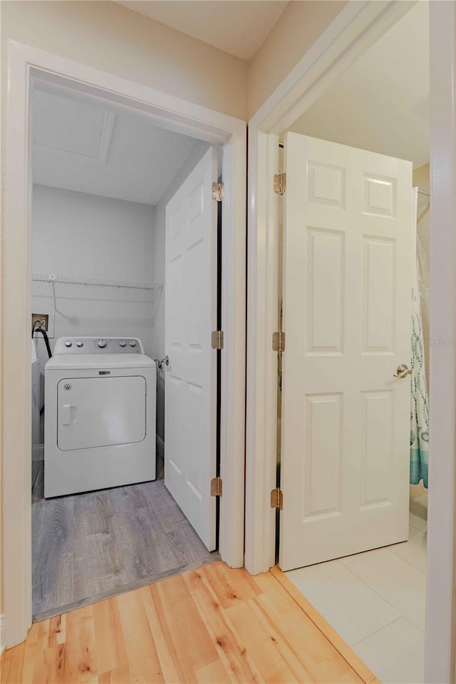 laundry area with hardwood / wood-style floors and washer / clothes dryer