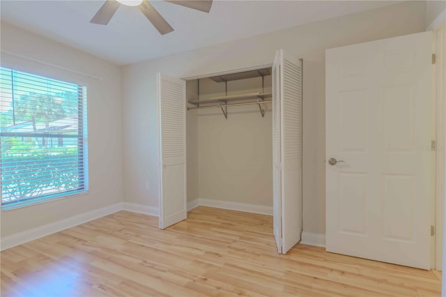 unfurnished bedroom featuring a closet, light wood-type flooring, and ceiling fan