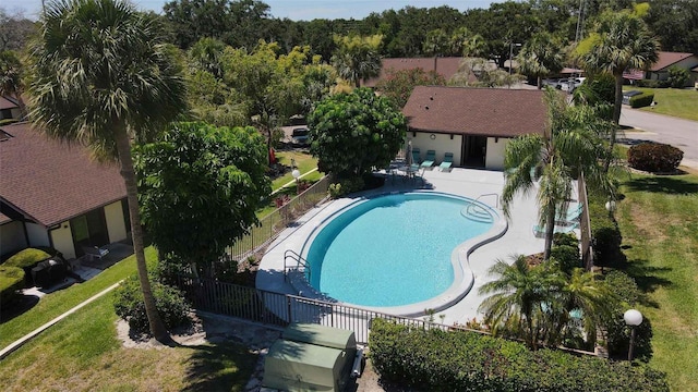 view of swimming pool featuring a patio and a yard