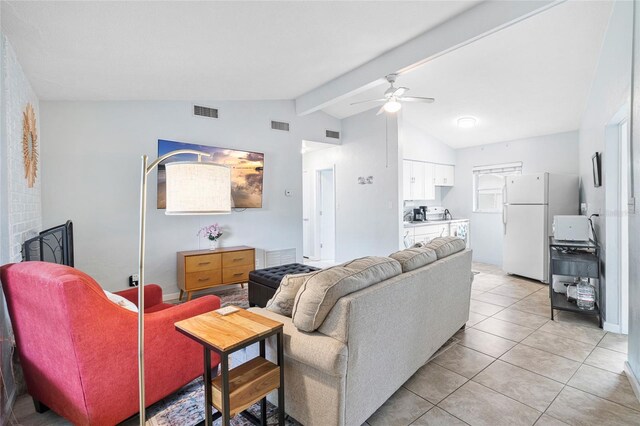 living room with lofted ceiling with beams, ceiling fan, and light tile patterned flooring