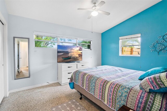 carpeted bedroom featuring ceiling fan and lofted ceiling